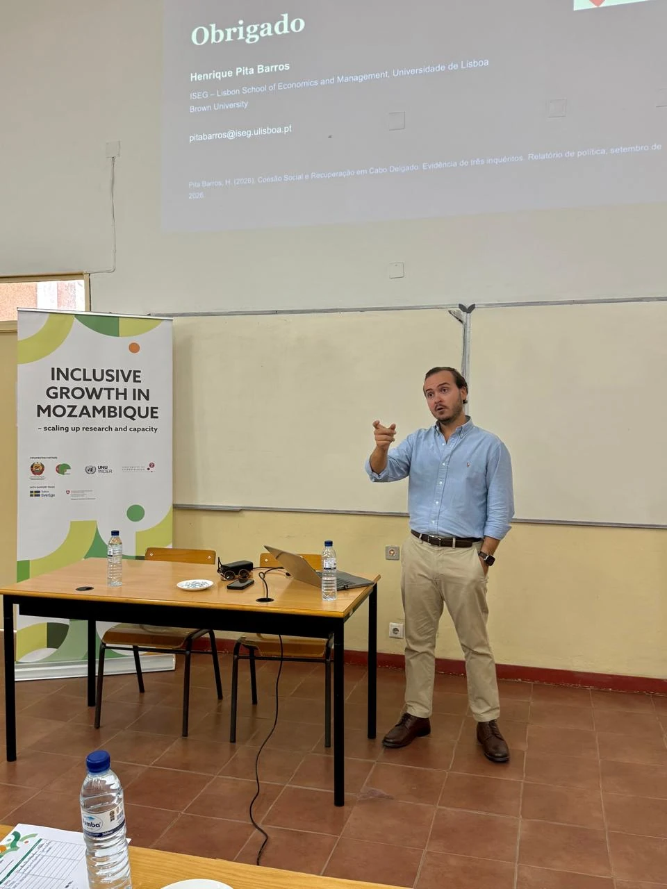 Henrique Pita Barros giving an IGM lecture beside a board and projector