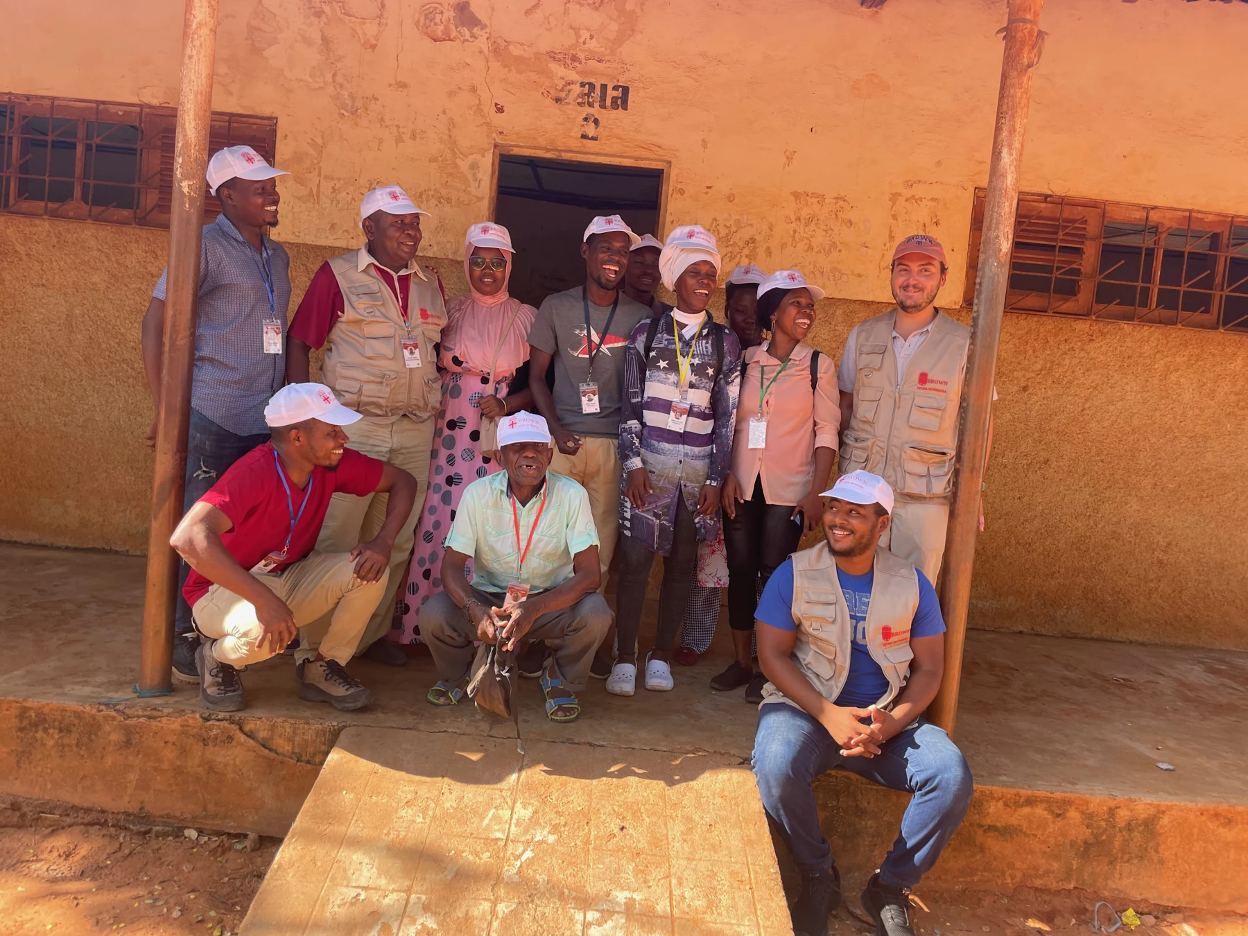 Henrique Pita Barros with his field team outside a building in Pemba
