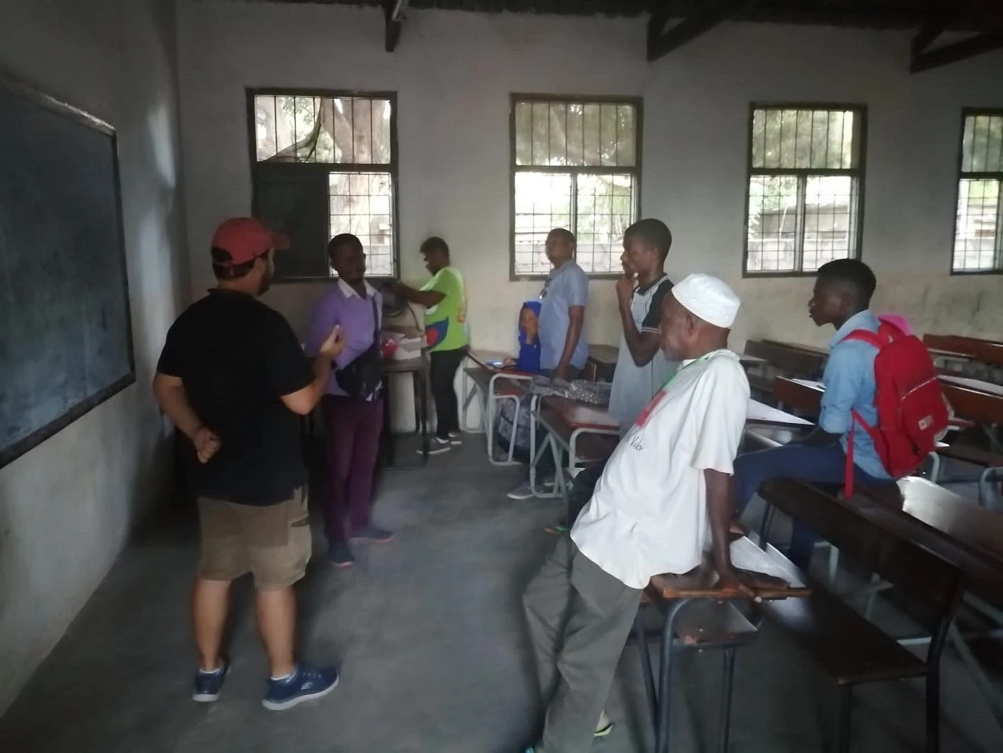 Henrique Pita Barros briefing his field team beside a classroom board